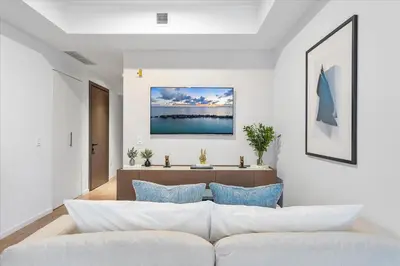 a living room with a white couch and blue pillows at MVR - Best Views in Downtown - Walk Everywhere in Miami