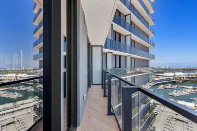 an apartment balcony with a view of a harbor at MVR - Miami-s #1 Rated 1BR - Sup3rhost Approved in Miami