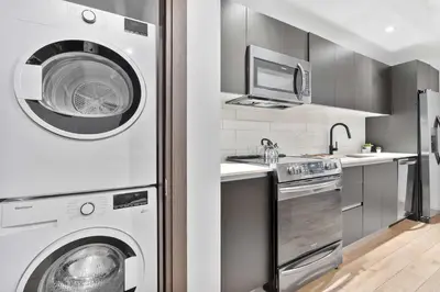 a kitchen with a washing machine and a washer at MVR - SupErhost Stay 10 Yrs of 5-Star Service in Miami