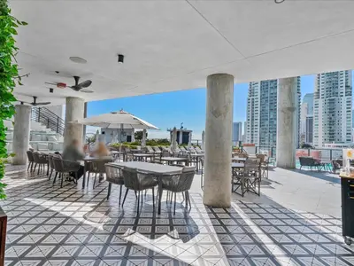 a patio with tables and chairs on a building at MVR - SupErhost Stay 10 Yrs of 5-Star Service in Miami