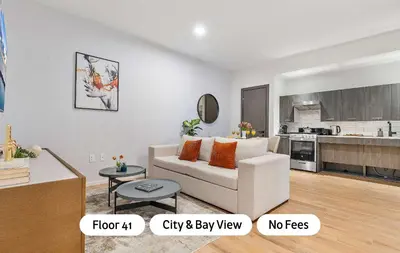 a living room with a white couch and a kitchen at MVR - VIP Pool Deck & Rooftop Lounge Access in Miami