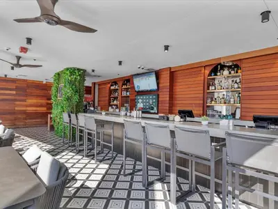 a restaurant with a bar with chairs at MVR - Last-Minute Deal Luxe Stay in Downtown in Miami