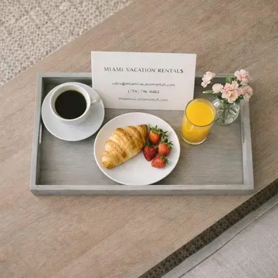 a tray with a breakfast plate with a cup of coffee and strawberries at MVR - Last-Minute Deal Luxe Stay in Downtown in Miami