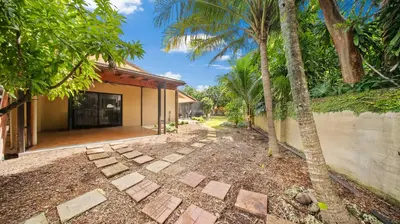a walkway in front of a house with palm trees at Luxury Queen Room, Walk to UM, Free Car Service! in Miami