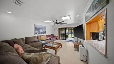 a living room with a couch and a table at Luxury Queen Room, Walk to UM, Free Car Service! in Miami