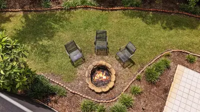 an overhead view of a fire pit with chairs in a yard at Luxury Queen Room, Free Car Service, Walk to UM! in Miami