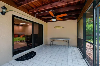 a patio with a table and a ceiling fan at Large Private Room, Free Car Service, Walk to UM! in Miami