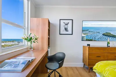 a bedroom with a desk and a chair and a window at MVR Relax in Suite with Biscayne Bay Sunsets in Miami