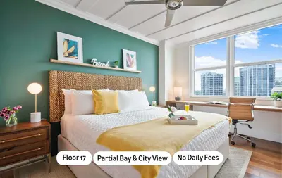 a bedroom with a bed and a desk and windows at MVR Suite with Picture-Perfect Views of Miami in Miami