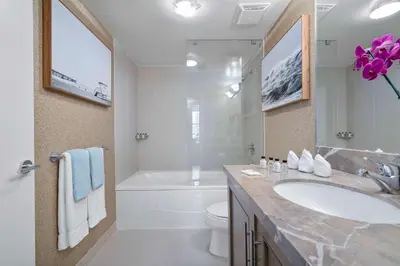 a bathroom with a sink and a tub and a toilet at MVR Suite with Picture-Perfect Views of Miami in Miami
