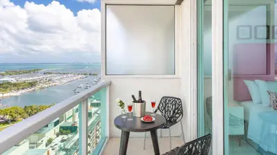 a balcony with a table and a view of the ocean at MVR Suite-A Stay That Feels Like a Private Resort in Miami