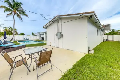 a patio with a table and chairs next to a building at Outdoor Oasis with Games Sleek Hollywood Home! in Hollywood