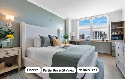 a bedroom with a large bed and a desk at MVR - A Suite That-s Actually as Good as It Looks in Miami