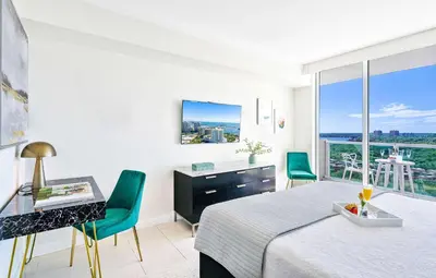 a bedroom with a bed and a desk and a window at MVR Suite in Grove-s Best-Kept Secret in Miami