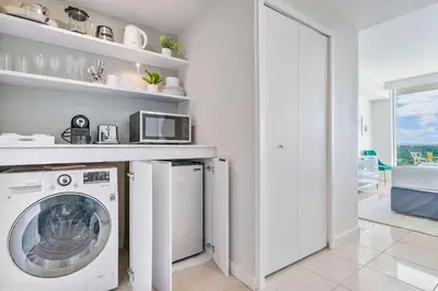 a white laundry room with a washer and dryer at MVR Suite in Grove-s Best-Kept Secret in Miami