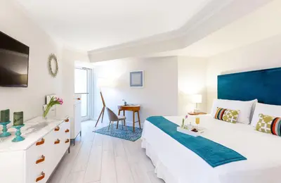 a white bedroom with a large bed and a desk at MVR Suite with Access to Miami-s Best Rooftop in Miami