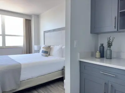 a white bedroom with a bed and a window at MVR Suite Boutique Living with Big Luxury Energy in Miami