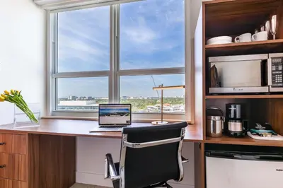 a kitchen with a desk with a laptop and a window at MVR A 5-Star Suite Feel Without Leaving the Grove in Miami