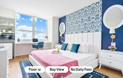 a bedroom with a bed and a desk with a mirror at MVR Suite The Secret to Luxury Living Is Right Here in Miami