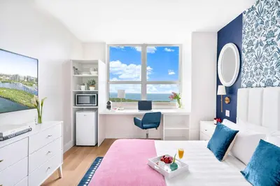 a room with a bed and a desk in it at MVR Suite The Secret to Luxury Living Is Right Here in Miami