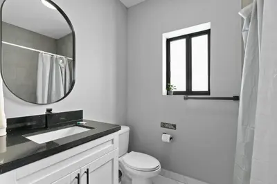 a white bathroom with a sink and a mirror at Spacious 4-BR House W Free Parking in Miami