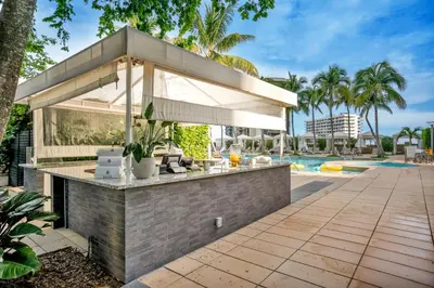 an outdoor bar with a pool in the background at Four Seasons Miami Two Bedroom - 2Bath Ocean view Suite - Amazing views in Miami