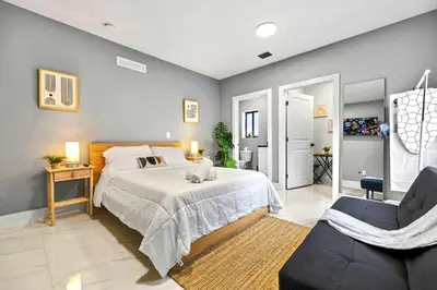 a bedroom with a large bed and a chair at Studio in Miami - Ideal for Couples & Travelers in Miami