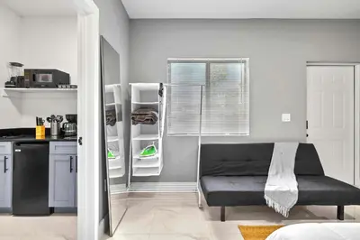 a kitchen with a refrigerator and a bench in a room at Studio in Miami - Ideal for Couples & Travelers in Miami