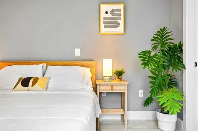 a bedroom with a bed and a table with a plant at Studio in Miami - Ideal for Couples & Travelers in Miami