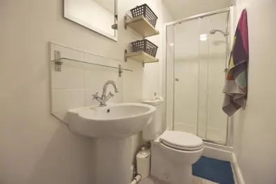 a white bathroom with a toilet and a sink at Gorgeous apartment near South Beach in Miami Beach
