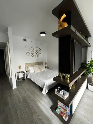 a bedroom with a bed and a tv in it at Luxury Studio in Miami