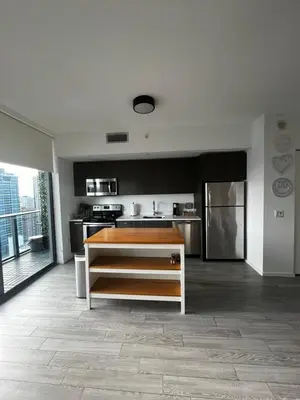 a large kitchen with a counter in a room at Luxury Studio in Miami