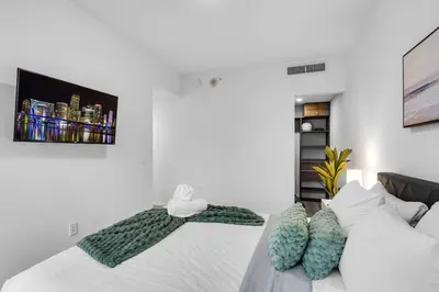 a bedroom with a bed with a green towel on it at Best Location 2 bedrooms 2 bathrooms in Miami
