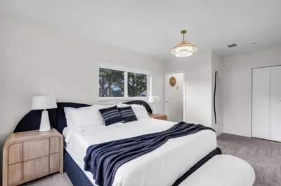 a bedroom with a large bed and a window at 4BR Biscayne River Home- Pool & Pickleball Fun home in Miami