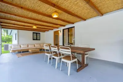 a dining room with a wooden table and chairs at 4BR Biscayne River Home- Pool & Pickleball Fun home in Miami