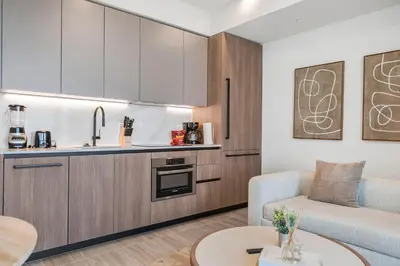 a kitchen and living room with a couch and a table at Luxury Miami Beach Condo At 72 Park in Miami Beach
