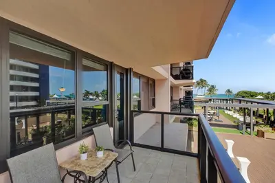 an apartment balcony with a table and chairs and windows at Cozy 2BR Condo with Resort Perks Pools Gym Sauna in an Oceanfront Building 409 in Miami Beach
