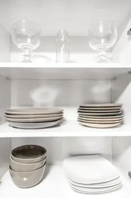 a white shelf with plates and bowls and glasses at Stylish 1BR Brickell Retreat Walk to Everything in Miami