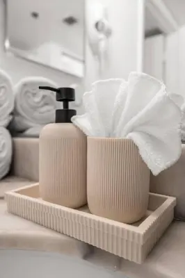 a soap dispenser sitting on a bathroom counter with towels at Stylish 1BR Brickell Retreat Walk to Everything in Miami