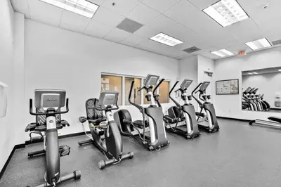 a gym with a row of cardio bikes and treadmills at Stylish 1BR Brickell Retreat Walk to Everything in Miami