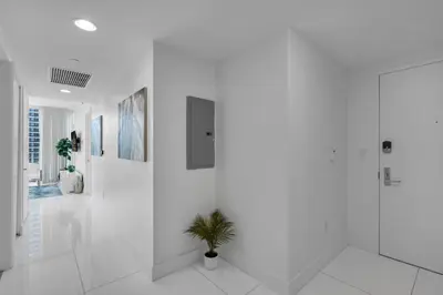 a white hallway with a potted plant in it at Icon Brickell 2BR Poolside Paradise in the Sky in Miami