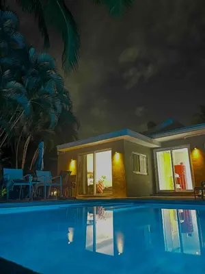 a house with a swimming pool at night at Chic Fort Lauderdale Getaway w/Private Heated Pool in Fort Lauderdale