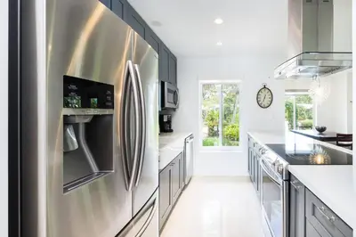 a kitchen with a stainless steel refrigerator at Chic Fort Lauderdale Getaway w/Private Heated Pool in Fort Lauderdale