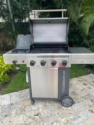 a barbecue grill with a laptop on top of it at Chic Fort Lauderdale Getaway w/Private Heated Pool in Fort Lauderdale