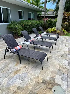 a row of black chairs sitting on a patio at Chic Fort Lauderdale Getaway w/Private Heated Pool in Fort Lauderdale