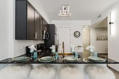 a dining room with a table with plates on it at Miami apartment style - Casino & Restaurants in Fort Lauderdale