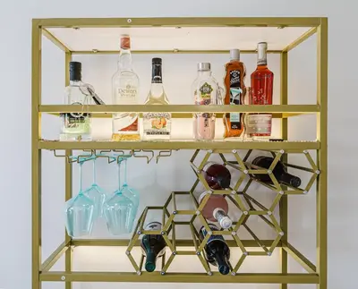 a shelf with alcohol bottles and glasses on it at Miami apartment style - Casino & Restaurants in Fort Lauderdale