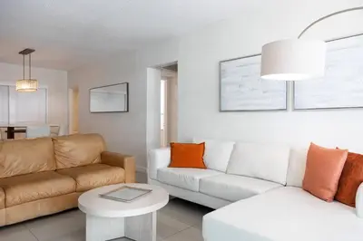 a living room with a couch and a table at Beachfront 2 BR Apt Full Kitchen - No Resort Fee in Hollywood
