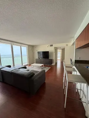 a large living room with a couch and a table at Bright 2BR Apartment in Prime Brickell Location in Miami