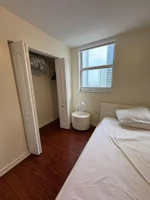an empty bedroom with a bed and a window at Bright 2BR Apartment in Prime Brickell Location in Miami